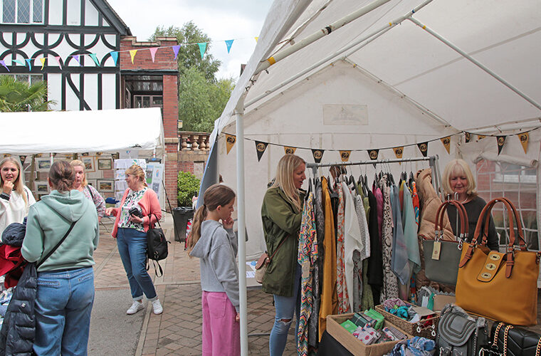 Visitors browsing the clothing and accessories stall